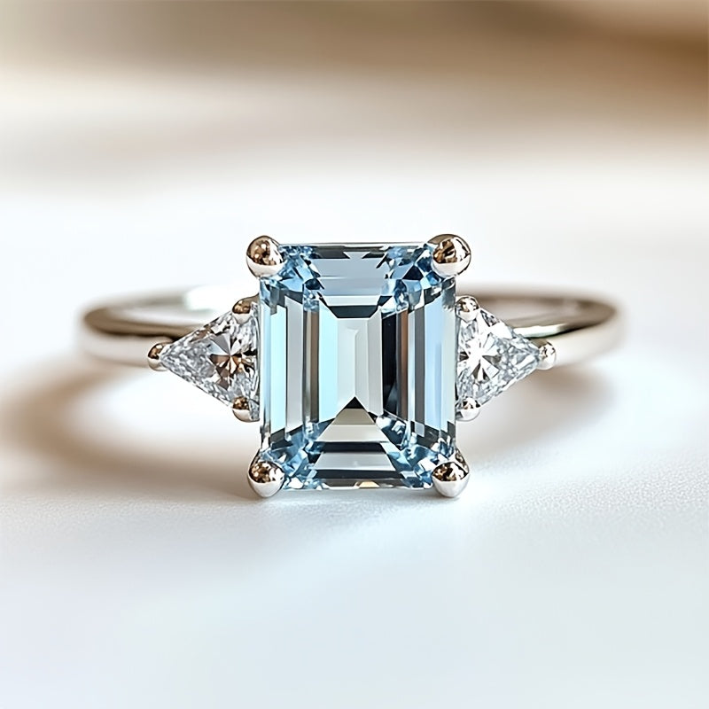 Custom Emerald-Cut Blue Topaz Three-Stone Engagement Ring